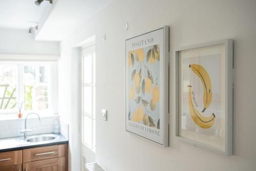a kitchen with two pictures of a banana on the wall at Central 1 Bed with Free Private Parking and Sofa Bed in Cheltenham