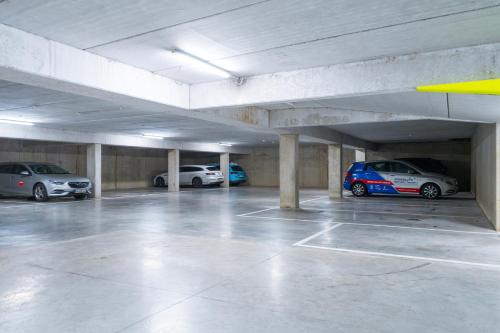a parking garage with several cars parked in it at Parkhotel Kortrijk in Kortrijk