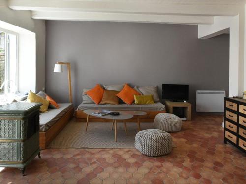 a living room with a couch and a table at Maison Les Portes-en-Ré, 4 pièces, 6 personnes - FR-1-434-17 in Les Portes