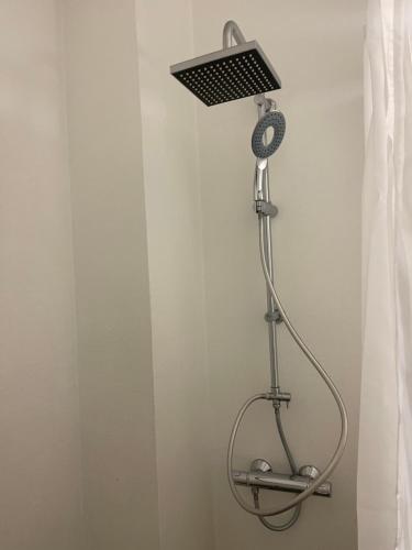 a shower head in a room with a shower curtain at VS-Guesthouse in Copenhagen