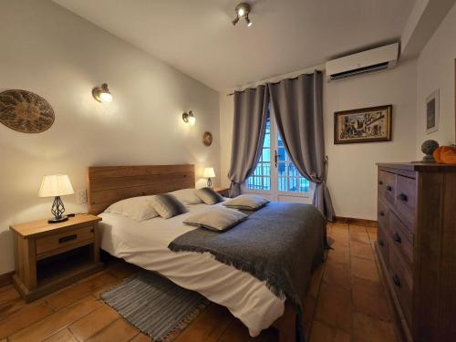 a bedroom with a large bed and a window at Villa Vuyani Antibes in Antibes