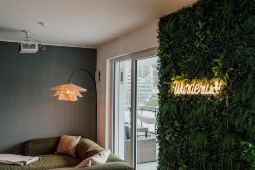 a living room with a green wall at Modern Apartm. Wanderlust with Home Cinema in Echternacherbrück