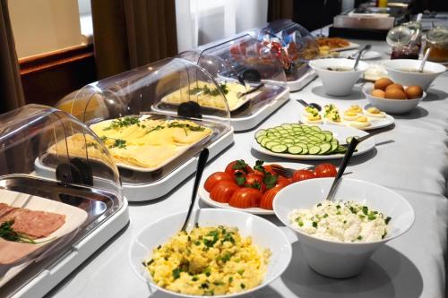 a buffet with different types of food on a table at Apartament 24 AbsyntApart Rynek Wrocław in Wrocław