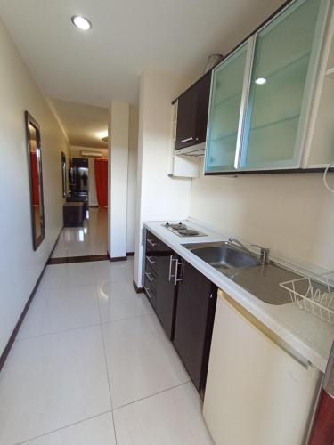 a kitchen with a sink and a counter top at Pensao Martins in Maputo