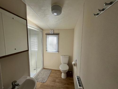 a small bathroom with a toilet and a shower at 28 Trent view in Cottam
