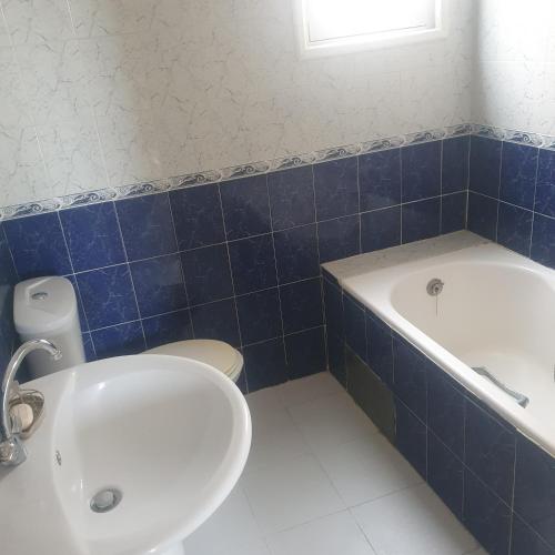 a bathroom with a tub and a toilet and a sink at Maison de vacances à la mer 5mn à pieds in Borj el Khessous
