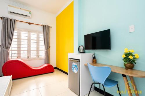 a room with a desk and a red chair at Mayhouse Vũng Tàu Hotel TPVT in Vung Tau
