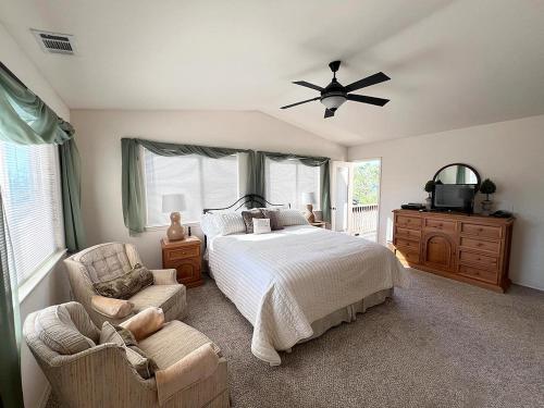 a bedroom with a bed and a fan and a chair at 555 Lancaster St. in Cambria