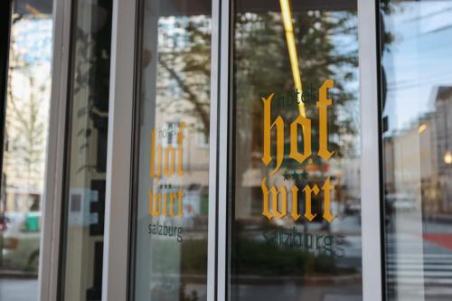 a close up of two glass doors with signs on them at Altstadt Hotel Hofwirt Salzburg in Salzburg