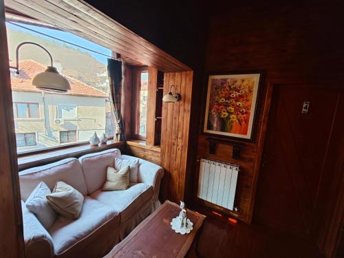 a living room with a couch and a window at Вила Тодора Villa Todora in Vratsa