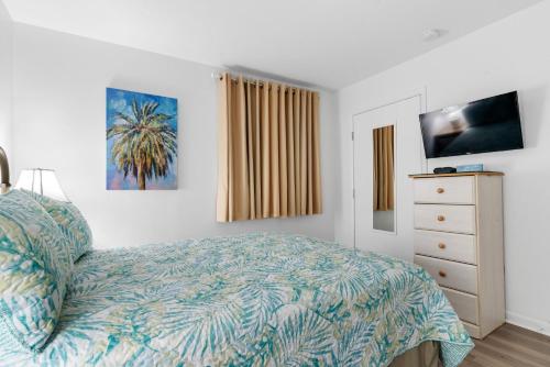 a bedroom with a bed and a dresser at Gulf Shores Plantation-East 3210 in Gulf Shores