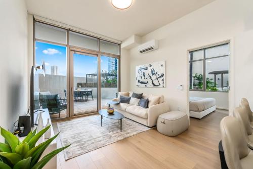 a living room with a couch and a table at Sky Ala Moana 809 condo in Honolulu