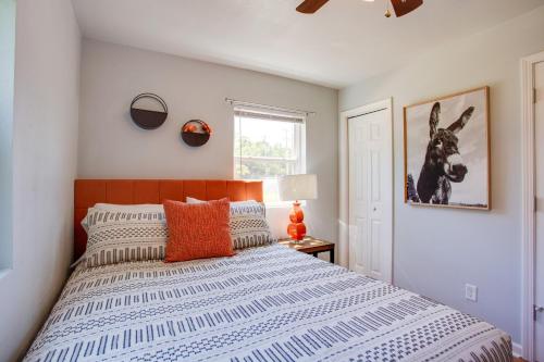 a bedroom with a bed with a horse picture on the wall at Walkable OSU Apartment - 6 Blocks to Stadium! in Stillwater
