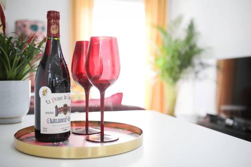 a bottle of wine and two glasses on a counter at Little Bright House in Whitstable