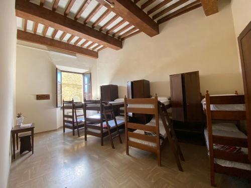 a dining room with a table and chairs in a room at Ostello San Marco Cortona in Cortona