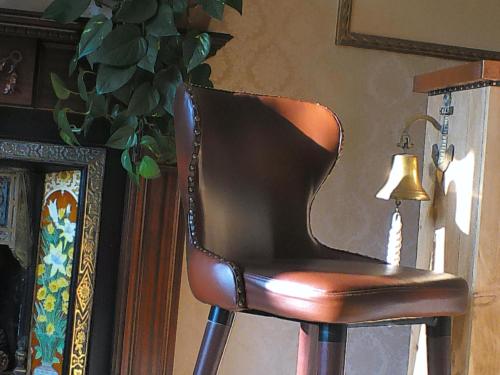 a brown leather chair sitting next to a lamp at Kingston House in Torquay