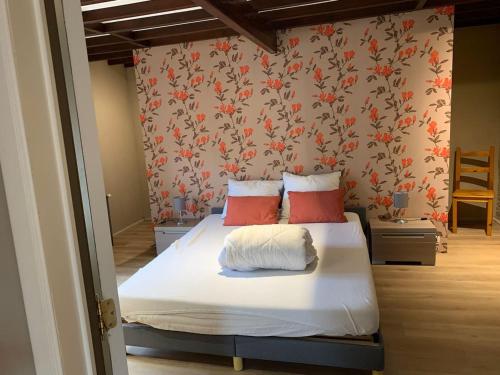 1 dormitorio con 1 cama con almohadas rojas en 3 bedrooms villa with private pool furnished terrace and wifi at Ohey, en Ohey