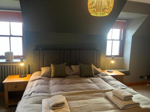 a bedroom with a large bed with two windows at Stein Inn in Stein