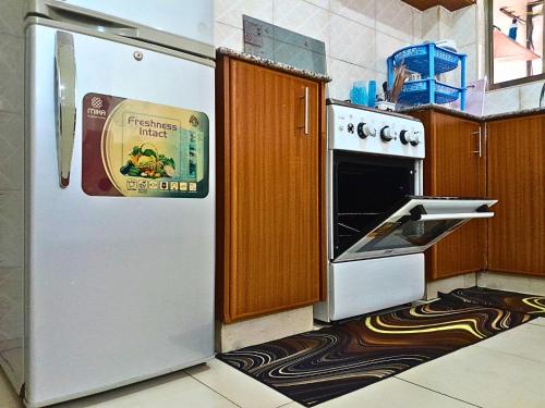 a kitchen with a white refrigerator with a sticker on it at The Chocolate House in Athi River