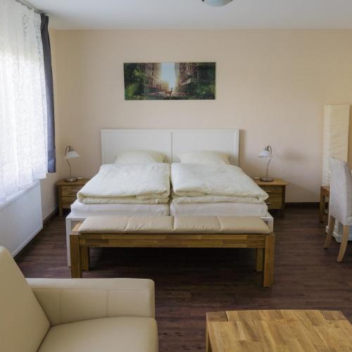 a bedroom with two beds and a couch at Ferienwohnung Vadrup in Westbevern