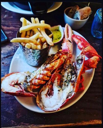 a plate of food with seafood and french fries at Stein Inn in Stein
