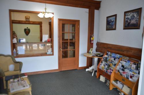 a room with a shop with a table and a window at Aquarius Motel in Perth