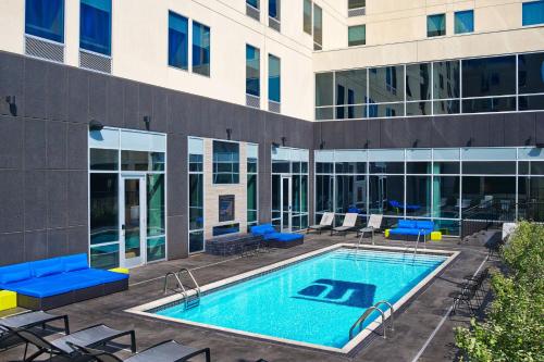 a swimming pool in front of a building at Aloft Oklahoma City Downtown – Bricktown in Oklahoma City