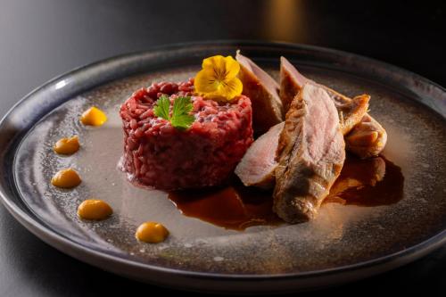 a plate of food with meat and chips on a table at Grand Hotel Zagreb in Zagreb