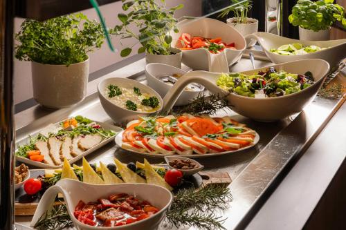 a buffet with many plates of food on a table at Grand Hotel Zagreb in Zagreb