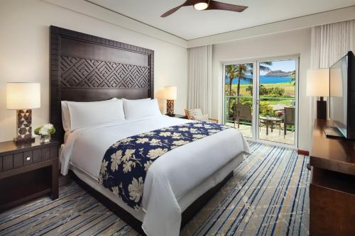 a bedroom with a large bed and a balcony at Marriott's Kauai Lagoons - Kalanipu'u in Lihue