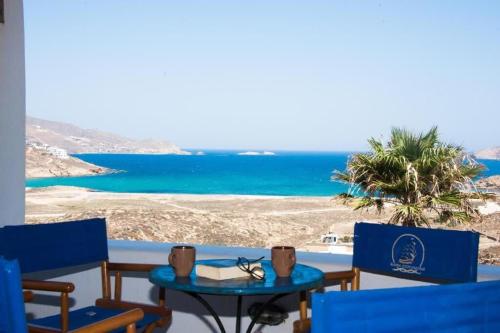 uma mesa e cadeiras com vista para o oceano em Mykonian Luxury Villa Victoria with Private Pool em Ftelia