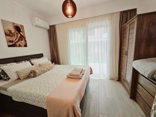 a bedroom with a bed and a large window at Sol Greco Apartment in Skala Rachoniou