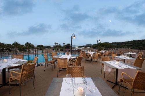 a restaurant with tables and chairs on a patio at Tanka Selected in Villasimius