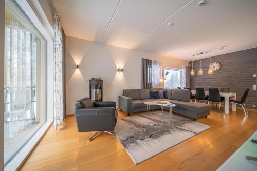 a living room with a couch and a table at LEVI Tunturinlaita A4, Ski-in Ski-out 3xBedroom in Levi