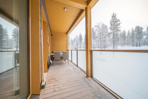 a balcony of a house with a view of the snow at LEVI Tunturinlaita A4, Ski-in Ski-out 3xBedroom in Levi