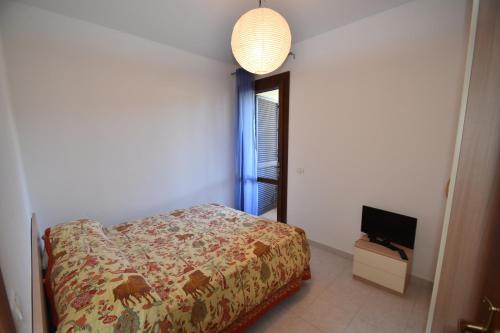 a bedroom with a bed and a flat screen tv at Trilocale Lacona Mare - Zona mare con clima e posto auto in Lacona