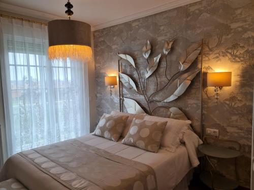 a bedroom with a bed with a tree mural on the wall at Casa A Pastora in Cambados