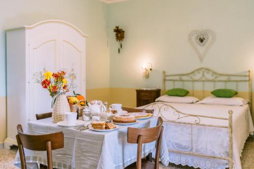 a room with a table with food and a bed at Lucy's guest house Amalfi coast in Tramonti