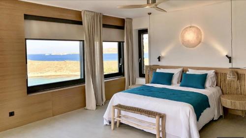 a bedroom with a bed and a large window at Villa Adokerodes in Ornos