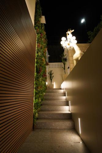 a stairway leading up to a building with a chandelier at Barneys B&b in Cercola