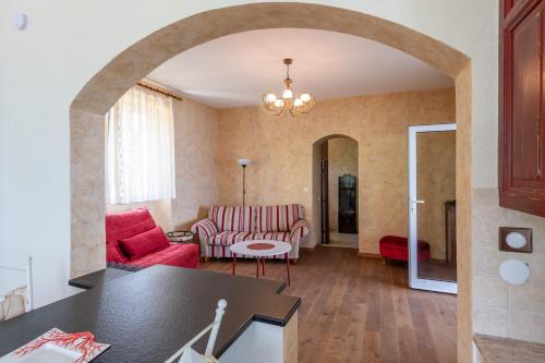 a living room with a red couch and a table at Villa Les Sources - Les pieds dans l'eau in Lugrin