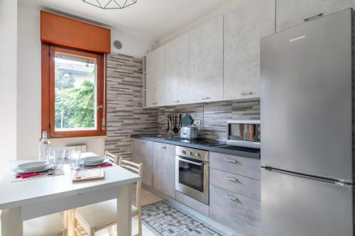 a kitchen with a white refrigerator and a table at Casa Miri - Padova in Padova