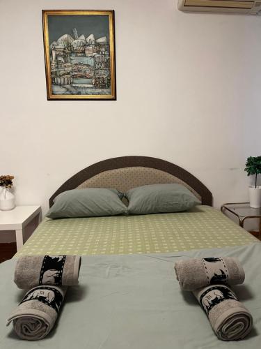 a bed in a bedroom with two towels on it at İstanbul apartment 2 in Belgrade