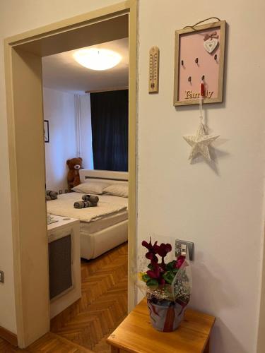 a room with a bedroom with a bed and a table at İstanbul apartment 2 in Belgrade