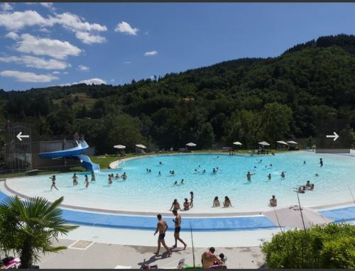 a group of people in a swimming pool at Chez Christian in Le Cheylard