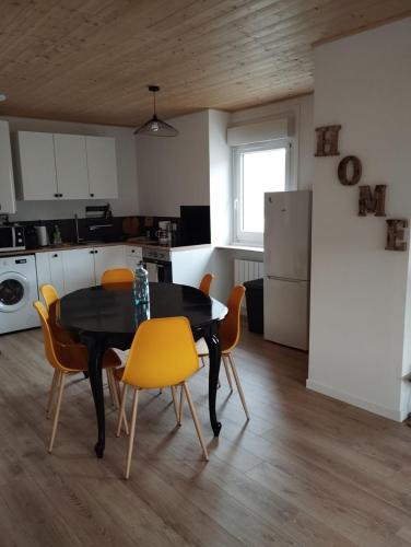 a kitchen and dining room with a table and chairs at Chez Christian in Le Cheylard