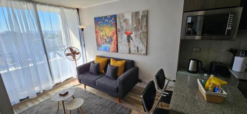 a living room with a couch and a tv at Best Apartment Rental Estación Central in Santiago