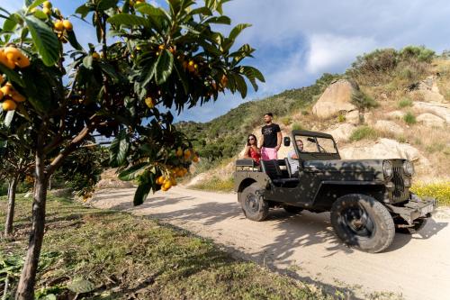 a man and woman in a jeep on a dirt road at Quinta da Terrincha in Torre de Moncorvo