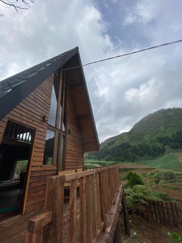a wooden house with a wooden fence around it at Satha private villa Dieng in Banjarnegara