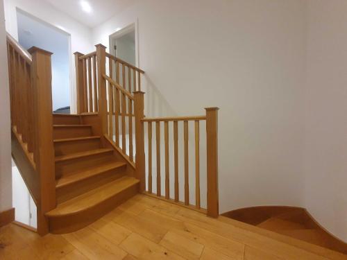 a staircase in a house with wooden floors at Bright 2Bed - 2Bath Flat - Kentish Town in London